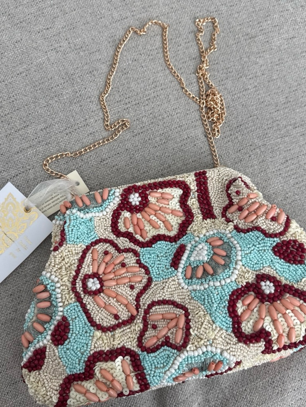 Beaded clutch purse with floral design in blue, beige, and burgundy